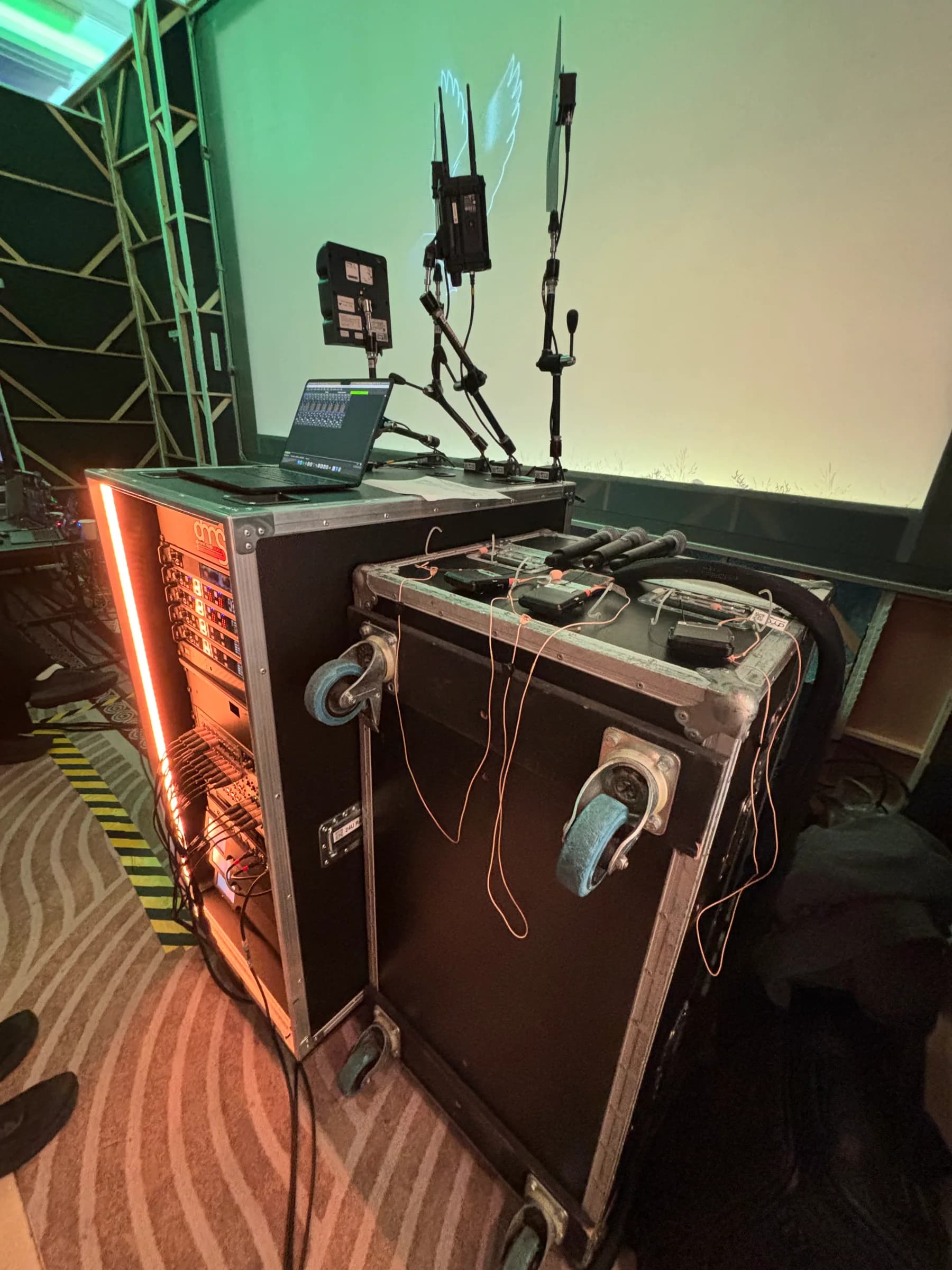 Backstage equipment rack, laptop, antennae and microphones on flight cases